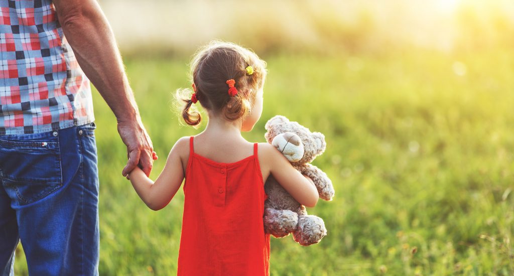 Father walks with Daughter in Field where He Sprayed Round-Up