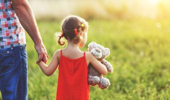 Father walks with Daughter in Field where He Sprayed Round-Up