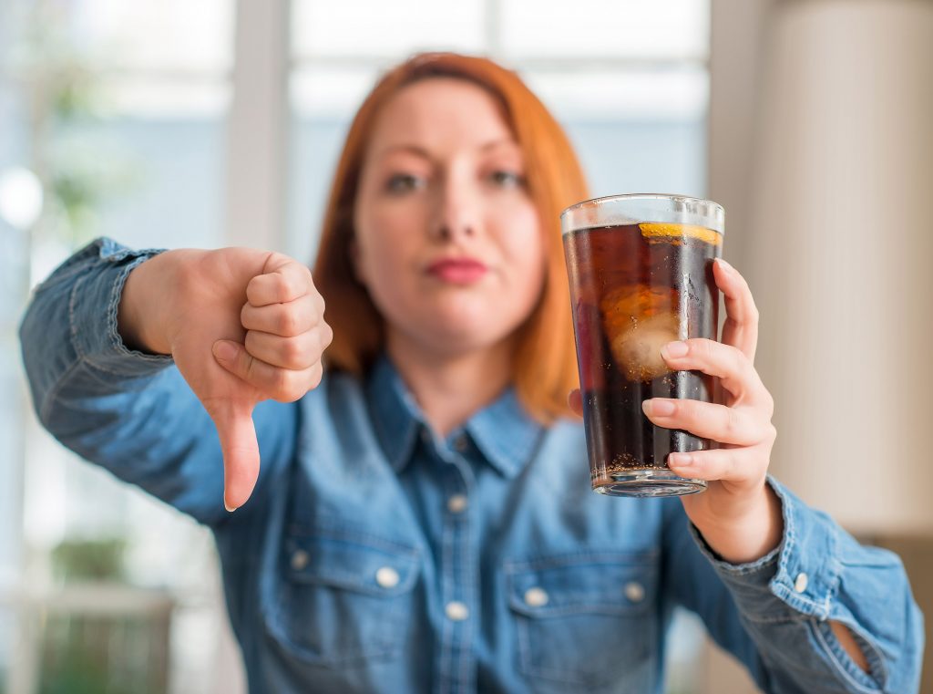Woman Gives Thumbs Down to Soda Pop