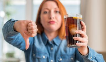 Woman Gives Thumbs Down to Soda Pop