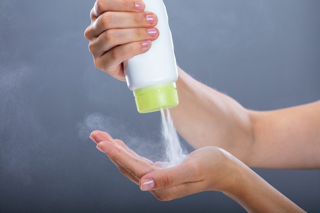 Woman Pouring Out Talc Powder